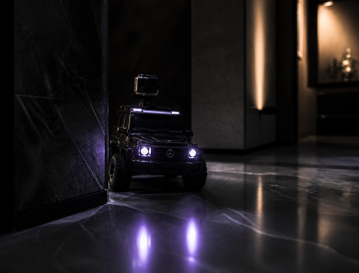 FURTIVO peeking around a dark marble corridor corner